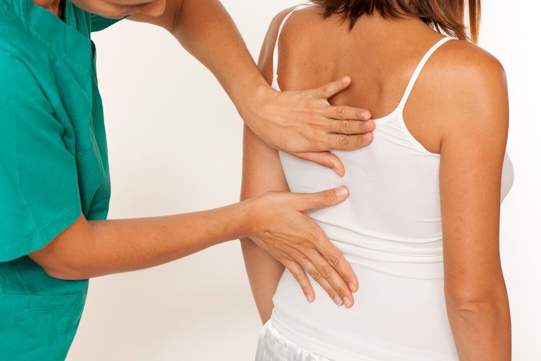 the doctor examines the back for pain in the shoulder area